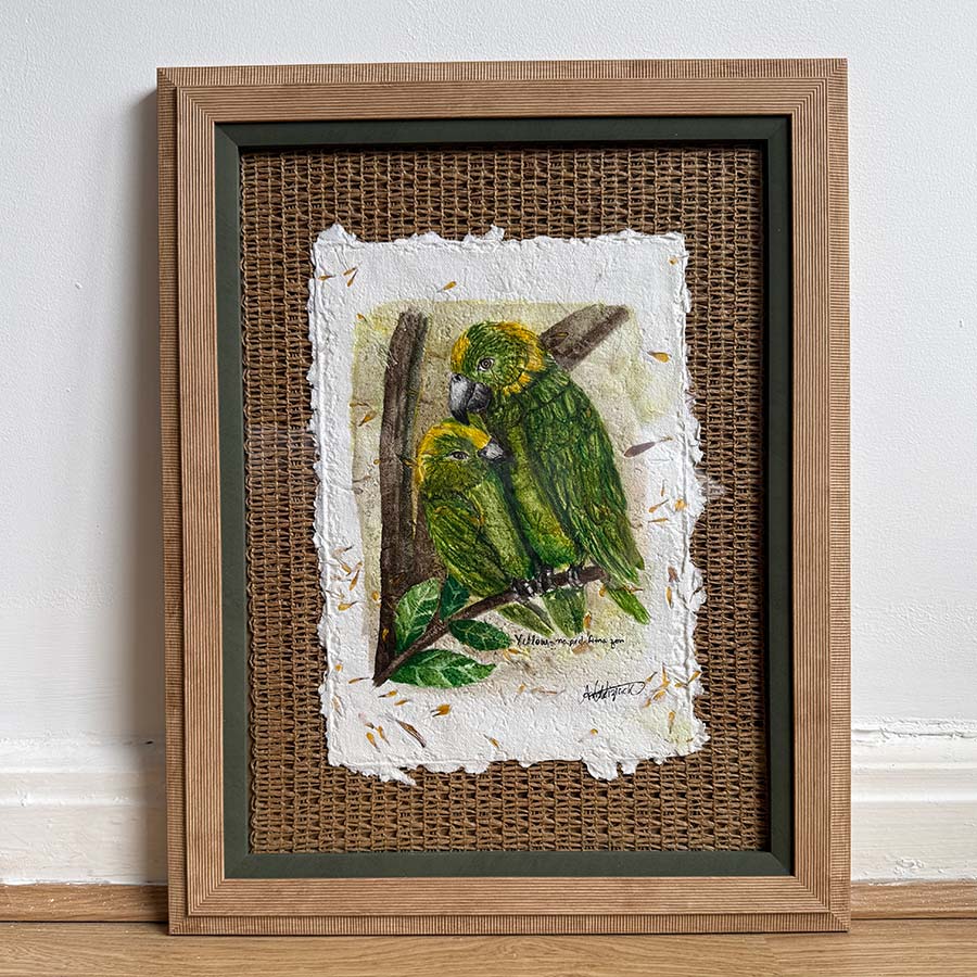 Framed artwork of a green parrot on a textured background