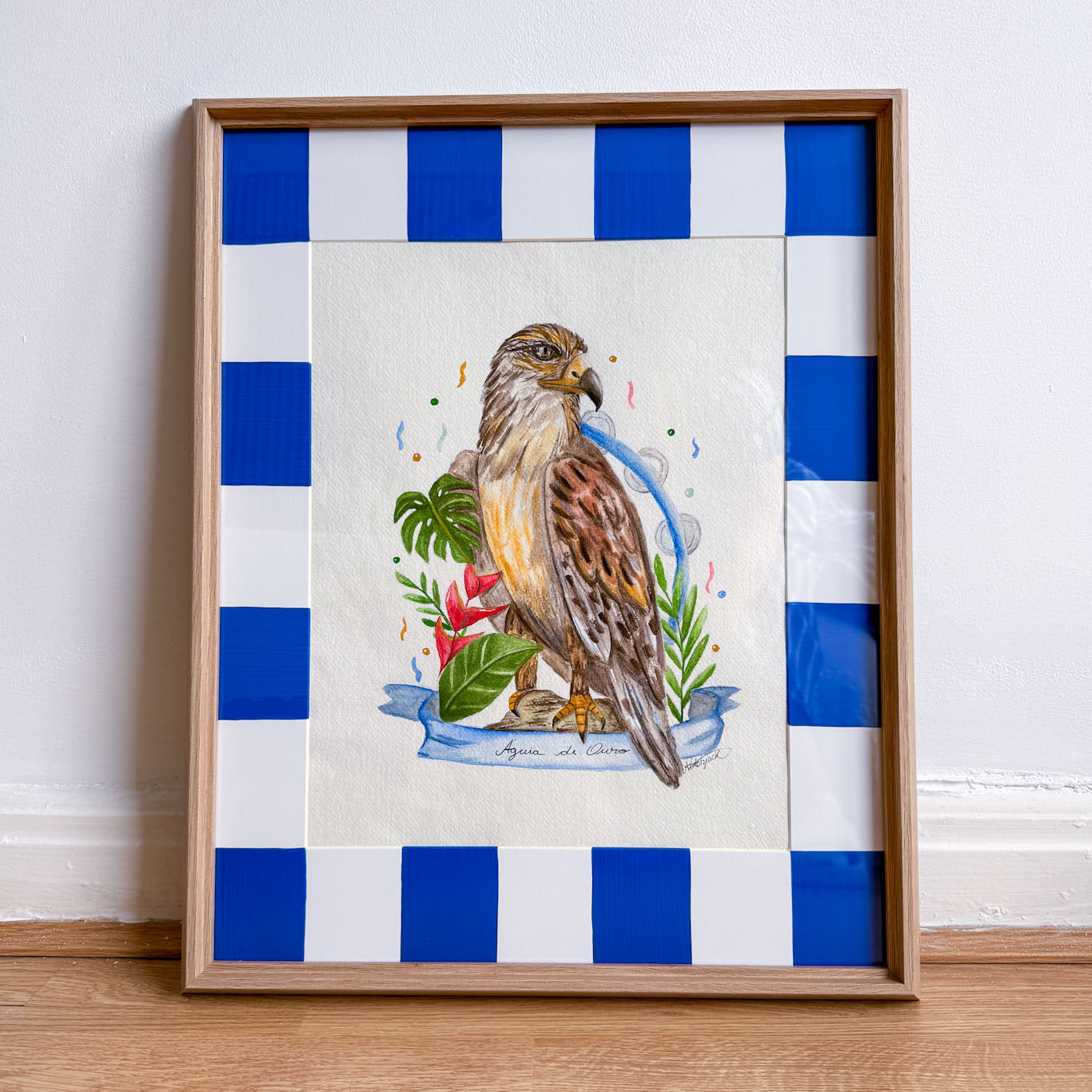 Framed artwork of a bird with blue and white striped background