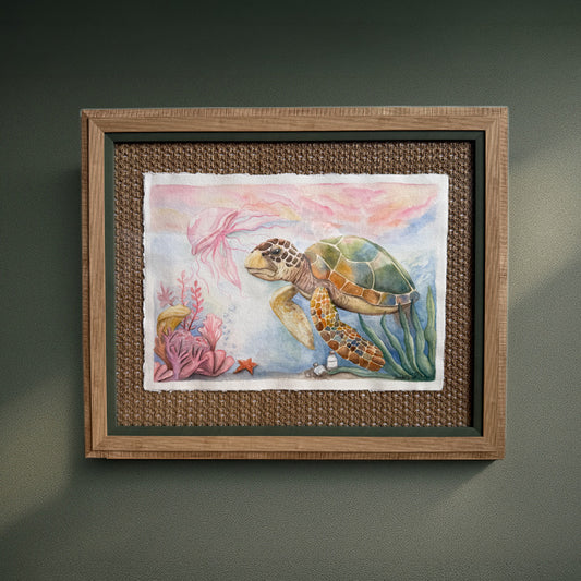 Framed artwork of a turtle in an underwater scene with coral.