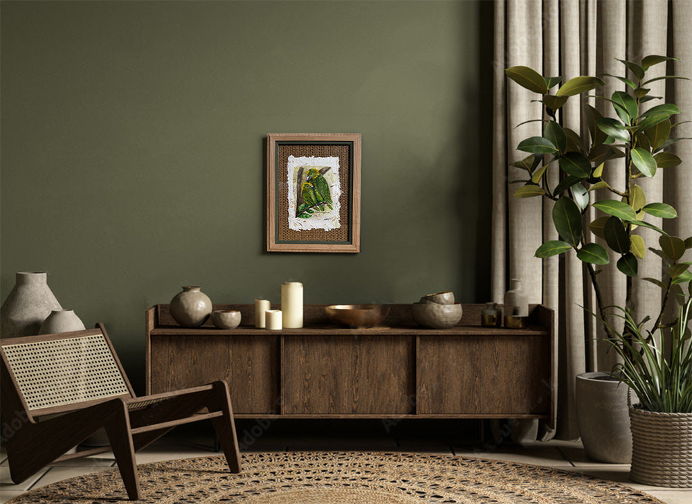 Living room with wooden cabinet, chair, and plant against a green wall.